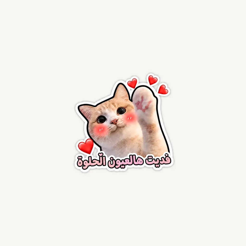 A die-cut sticker featuring a cute orange and white cat with pink cheeks and raised paws, surrounded by small red hearts, with Arabic text below in pink and white.