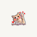 A die-cut sticker featuring a cute orange and white cat with pink cheeks and raised paws, surrounded by small red hearts, with Arabic text below in pink and white.