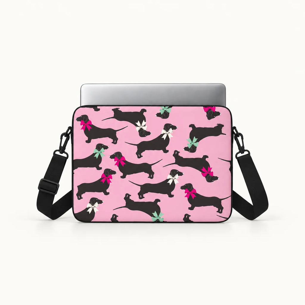 Seamless pattern of black dachshund dogs wearing colorful pink white and green ribbons on a pink padded laptop sleeve by SLEEVER