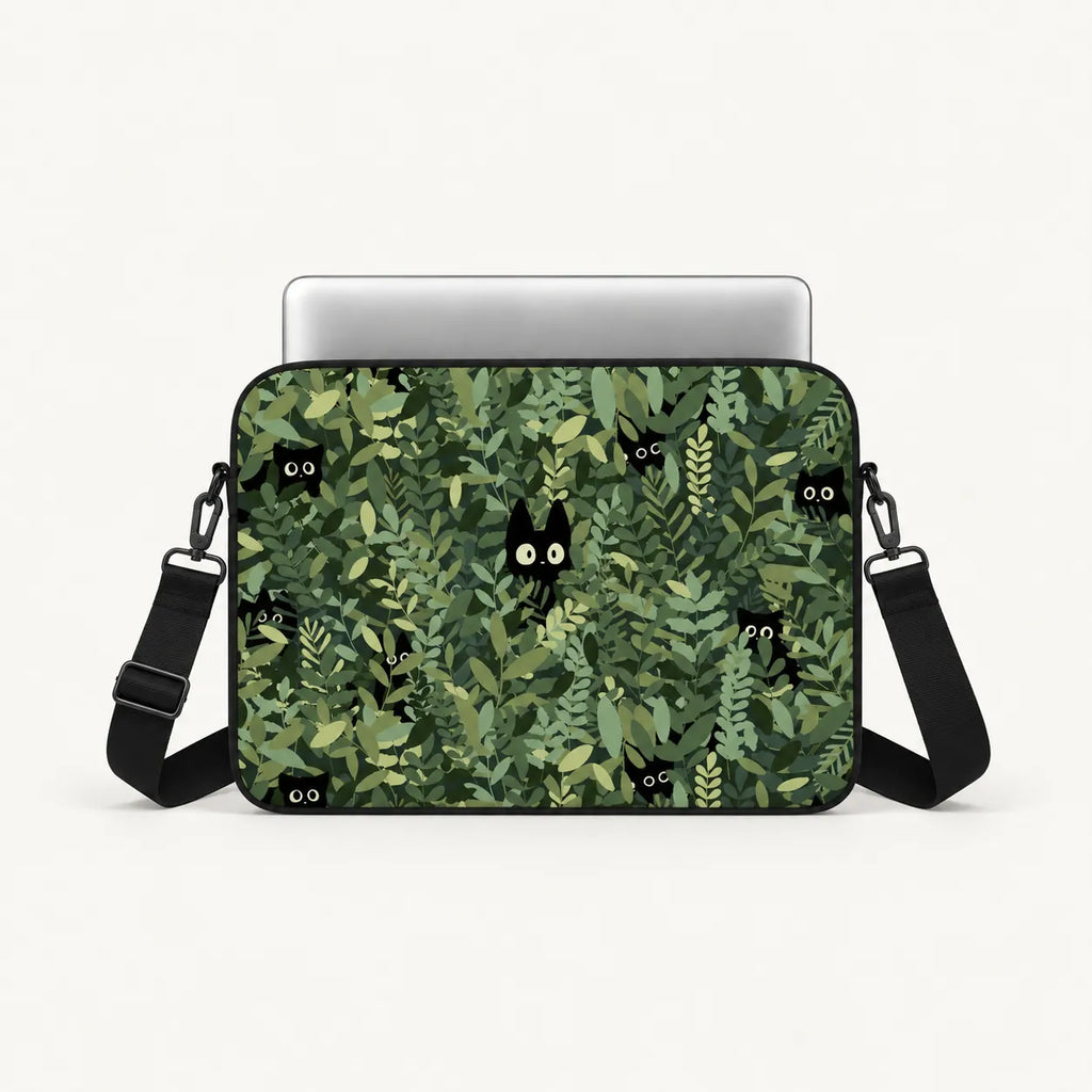 Cute black cats hiding in green leaves pattern on a padded laptop sleeve by SLEEVER