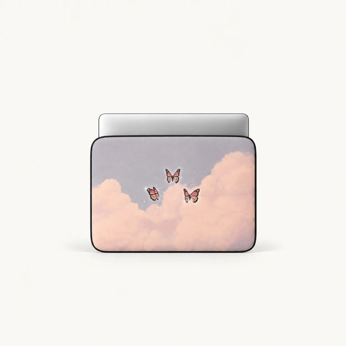 A laptop sleeve featuring a pastel pink and lavender cloud design with three small butterflies, shown on a clean off-white background.