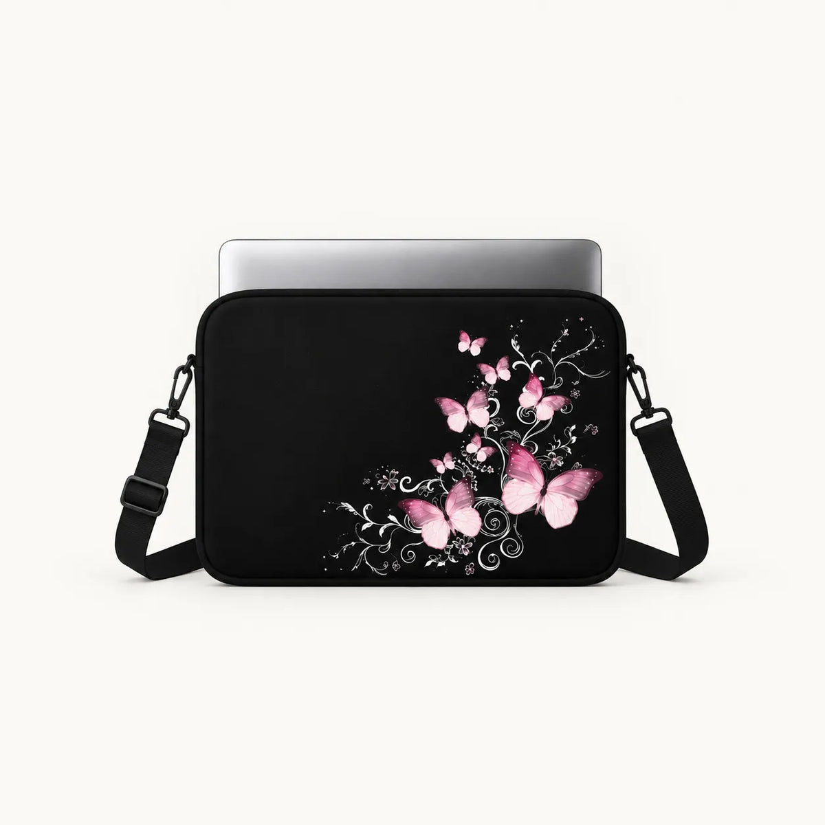 Elegantly glowing pink butterflies floating over silvery swirl vines on a black padded laptop sleeve by SLEEVER
