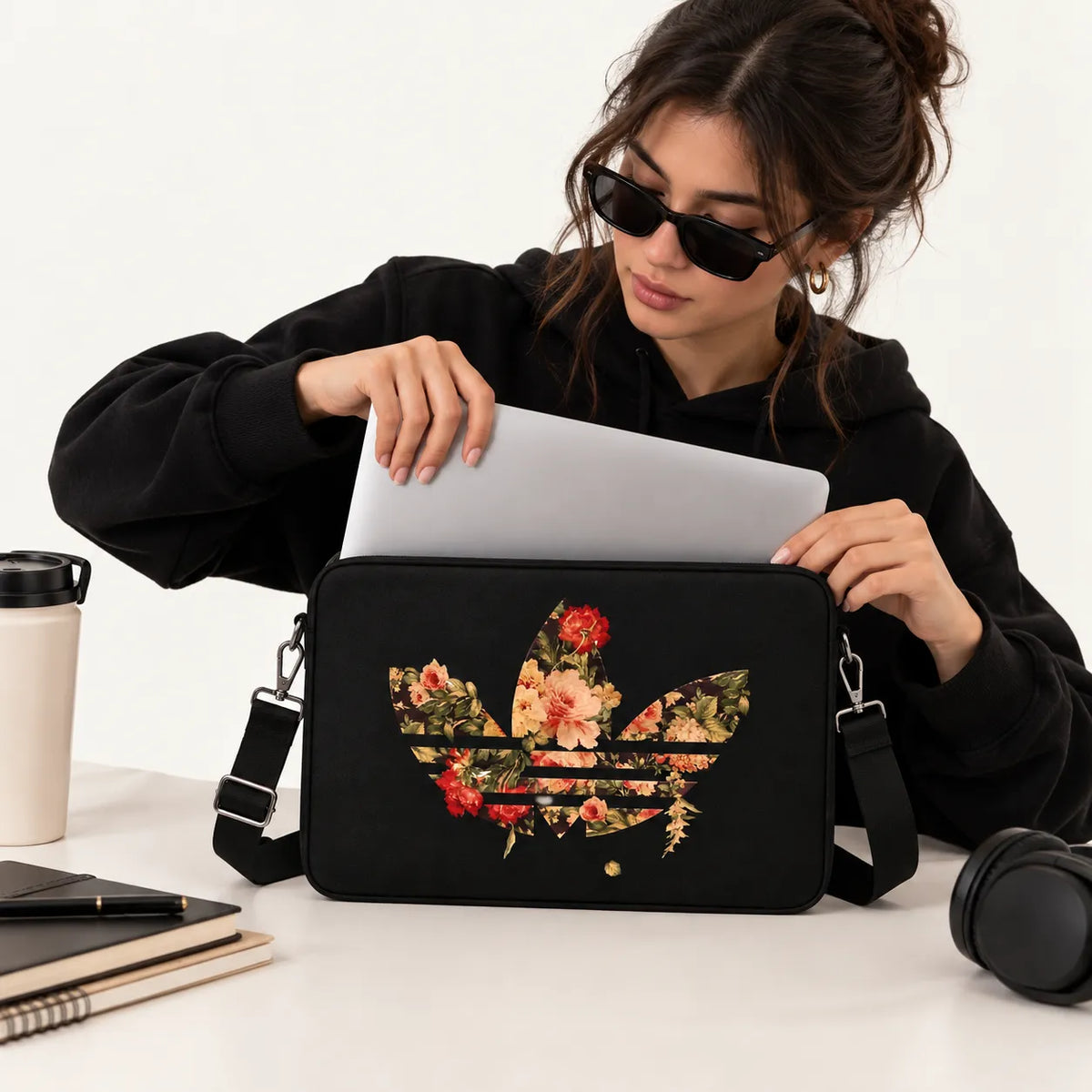 Vintage floral roses pattern inside a trefoil athletic logo silhouette on a black padded laptop sleeve by SLEEVER