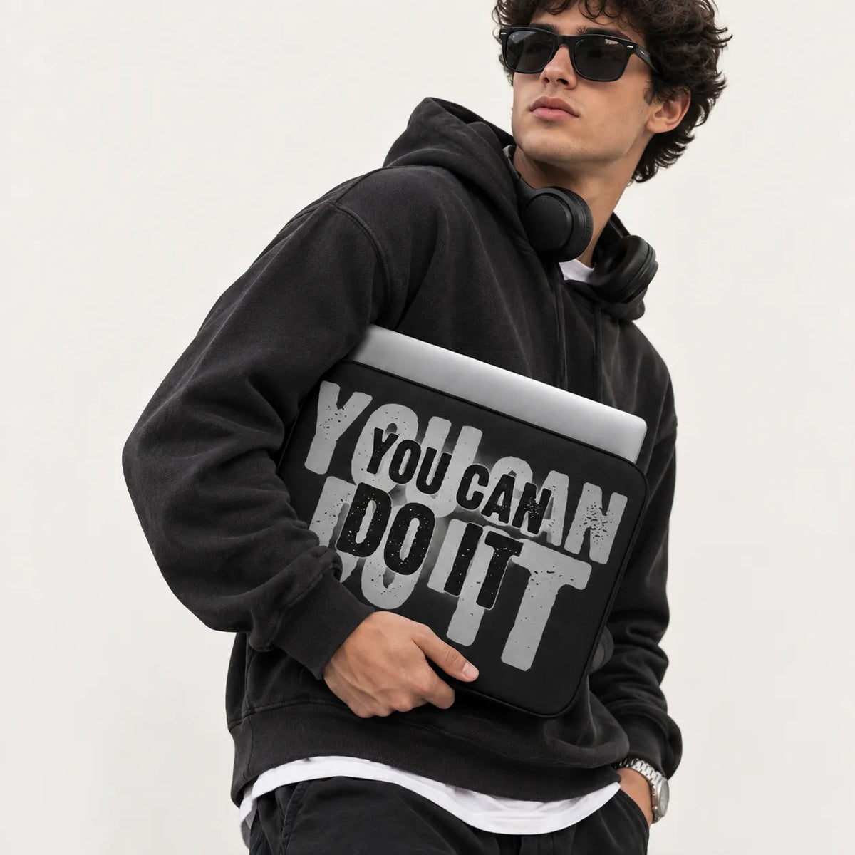 Layered bold textured typography reading You Can Do It in grey and black on a black padded laptop sleeve by SLEEVER