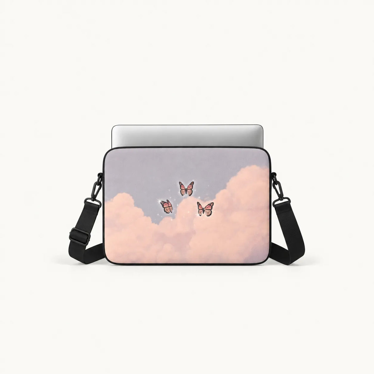 Pink butterflies flying among soft pink clouds in a pastel sky printed on a padded laptop sleeve by SLEEVER