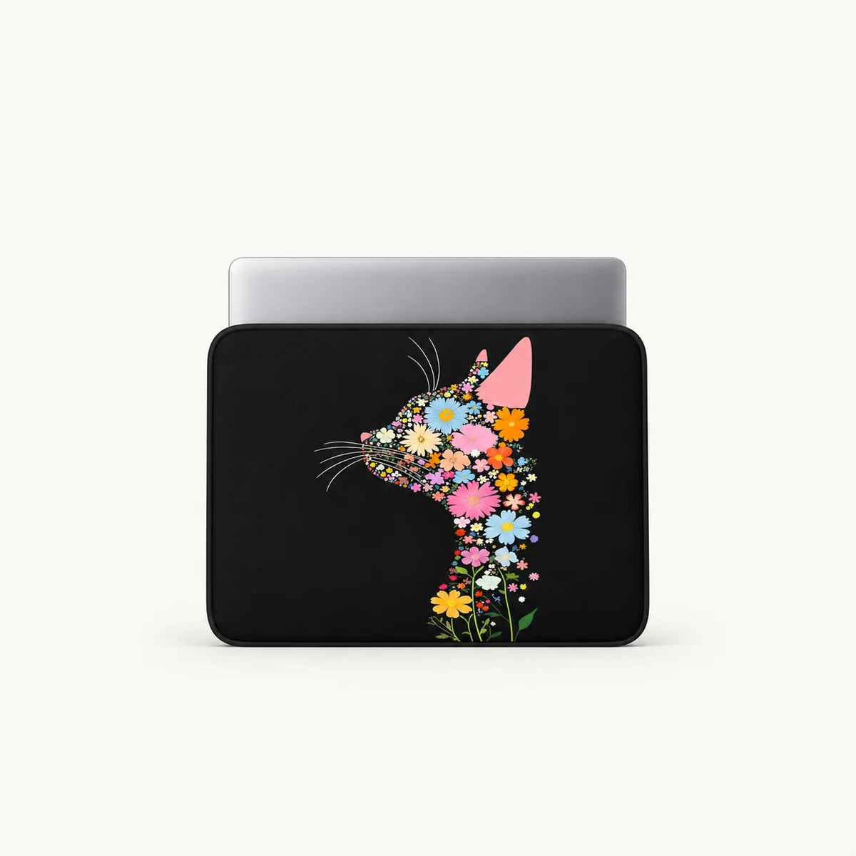 A black laptop sleeve featuring a stylized cat silhouette filled with colorful flowers, shown with a silver laptop inside on a light gray background.