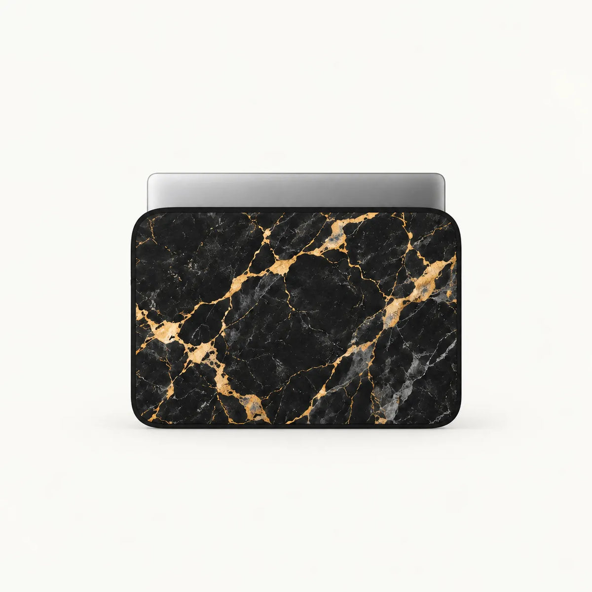 Front-view mock-up of SLEEVER padded laptop sleeve in black and gold marble pattern with silver laptop inside