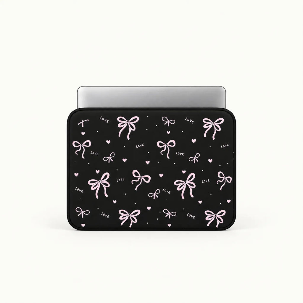 Pink ribbons bows and tiny hearts pattern printed on black padded laptop sleeve by SLEEVER