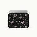 Pink ribbons bows and tiny hearts pattern printed on black padded laptop sleeve by SLEEVER