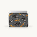 A laptop sleeve featuring a repeating pattern of black motorcycles and orange banners with the text 'Biker Club', shown on a light gray background with a silver laptop partially inserted.