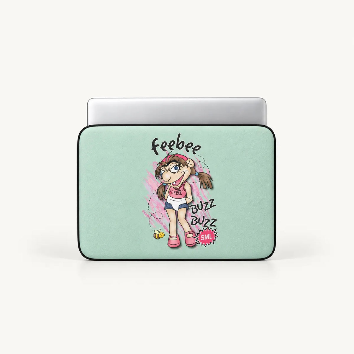 A laptop sleeve with a light mint green background and a colorful cartoon girl graphic, shown with a silver laptop partially inserted. The graphic includes the text 'Feebee' and 'BUZZ BUZZ BAIL!'.