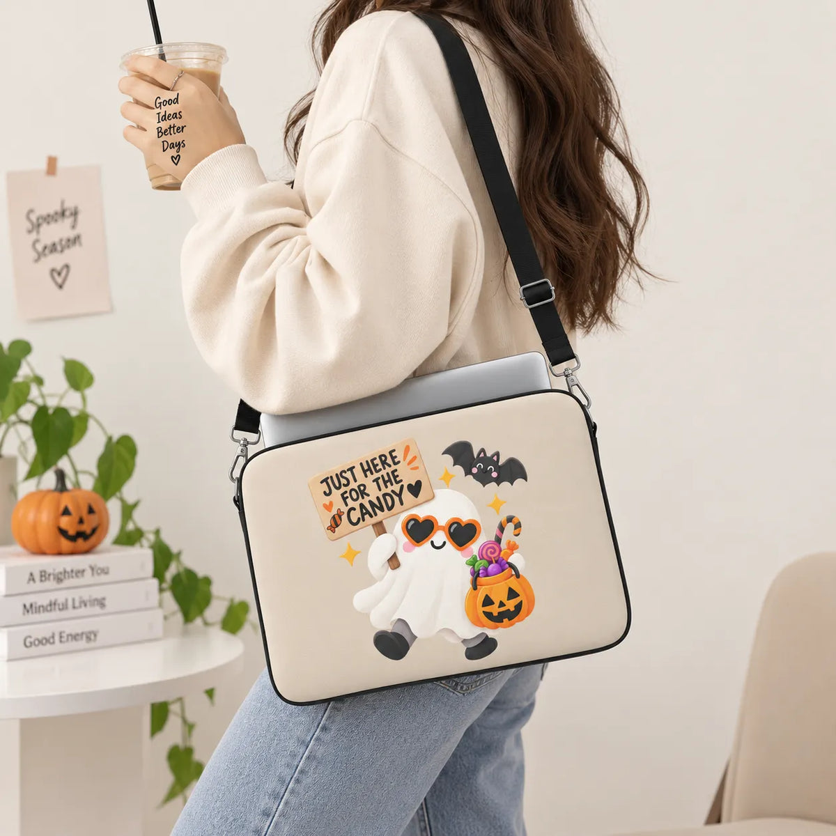 Cute friendly ghost wearing orange heart sunglasses holding a Just Here For The Candy sign and jack-o-lantern bucket with a cute bat on beige padded laptop sleeve by SLEEVER