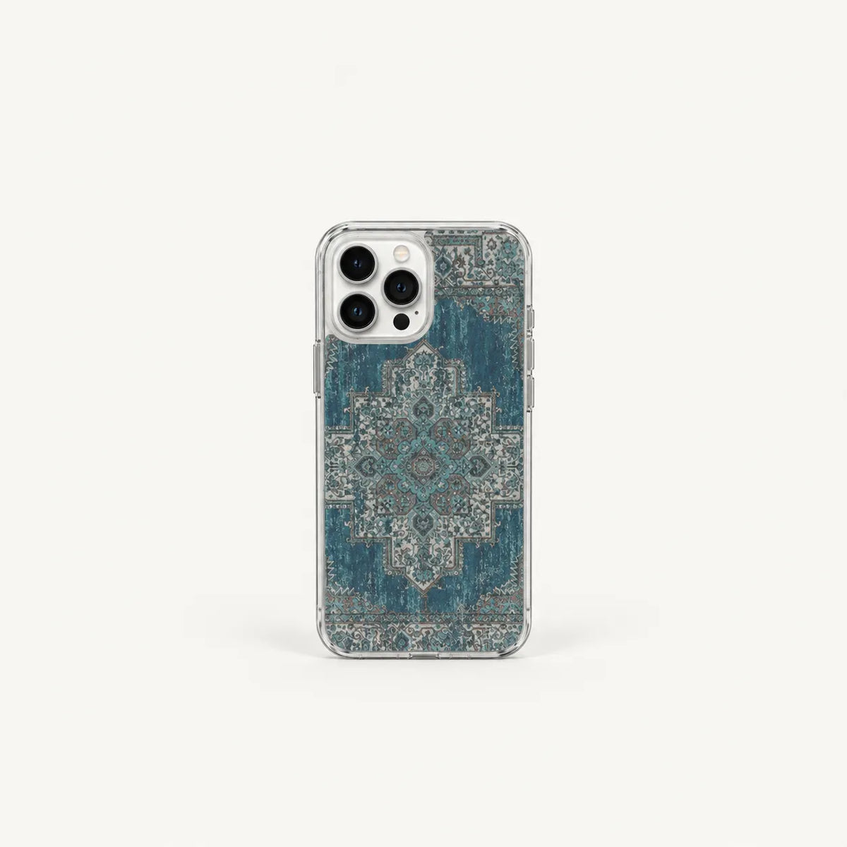 A clear phone case with a distressed blue and gray traditional rug pattern, shown on a light gray background.