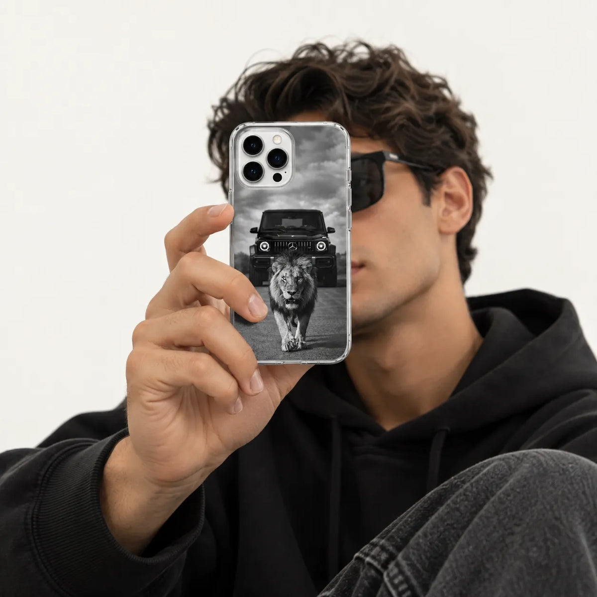 SLEEVER clear TPU phone case with black and white lion walking in front of a Mercedes G-Wagon UV print and magnetic charging compatibility   