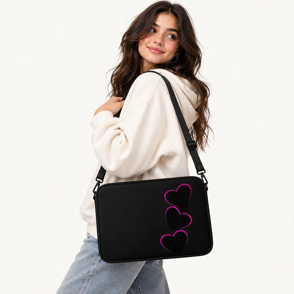 Three black hearts with glowing pink neon outlines stacked vertically on a black padded laptop sleeve by SLEEVER   