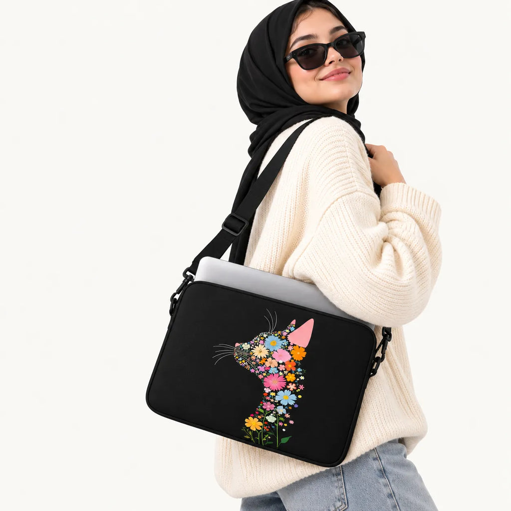Profile silhouette of a cat composed of colorful vibrant flowers on a black padded laptop sleeve by SLEEVER