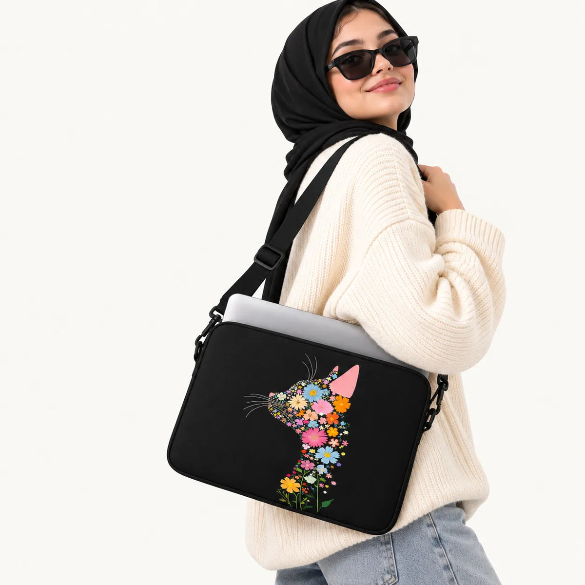 Profile silhouette of a cat composed of colorful vibrant flowers on a black padded laptop sleeve by SLEEVER