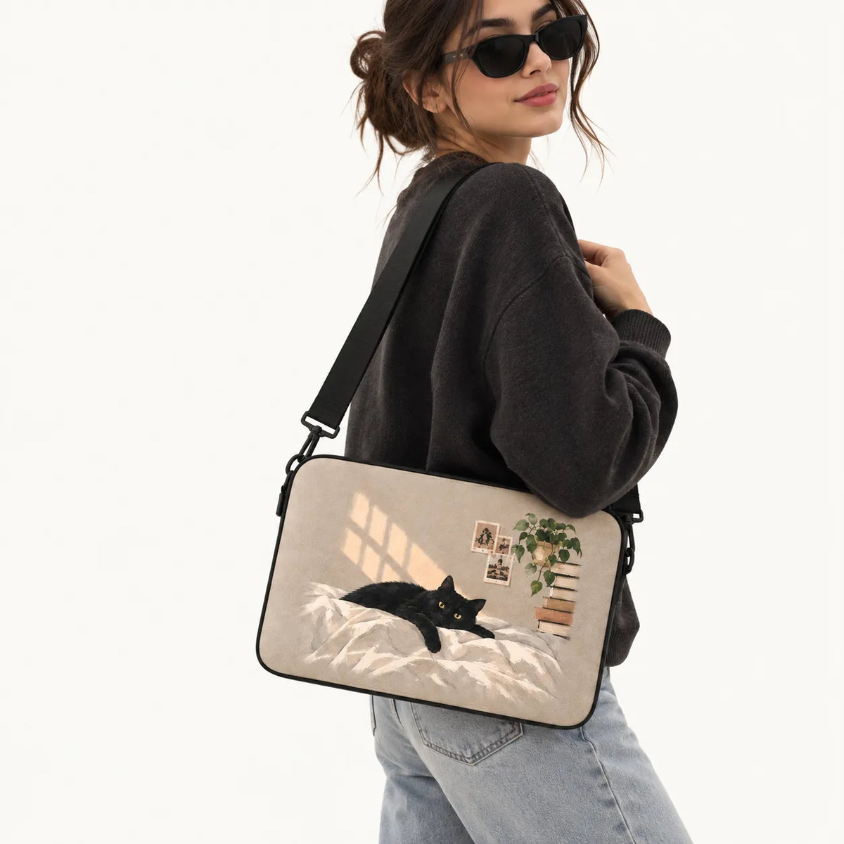 "SLEEVER 'Cozy Black Cat' laptop sleeve featuring an illustration of a black cat lounging on a bed in warm sunlight."   