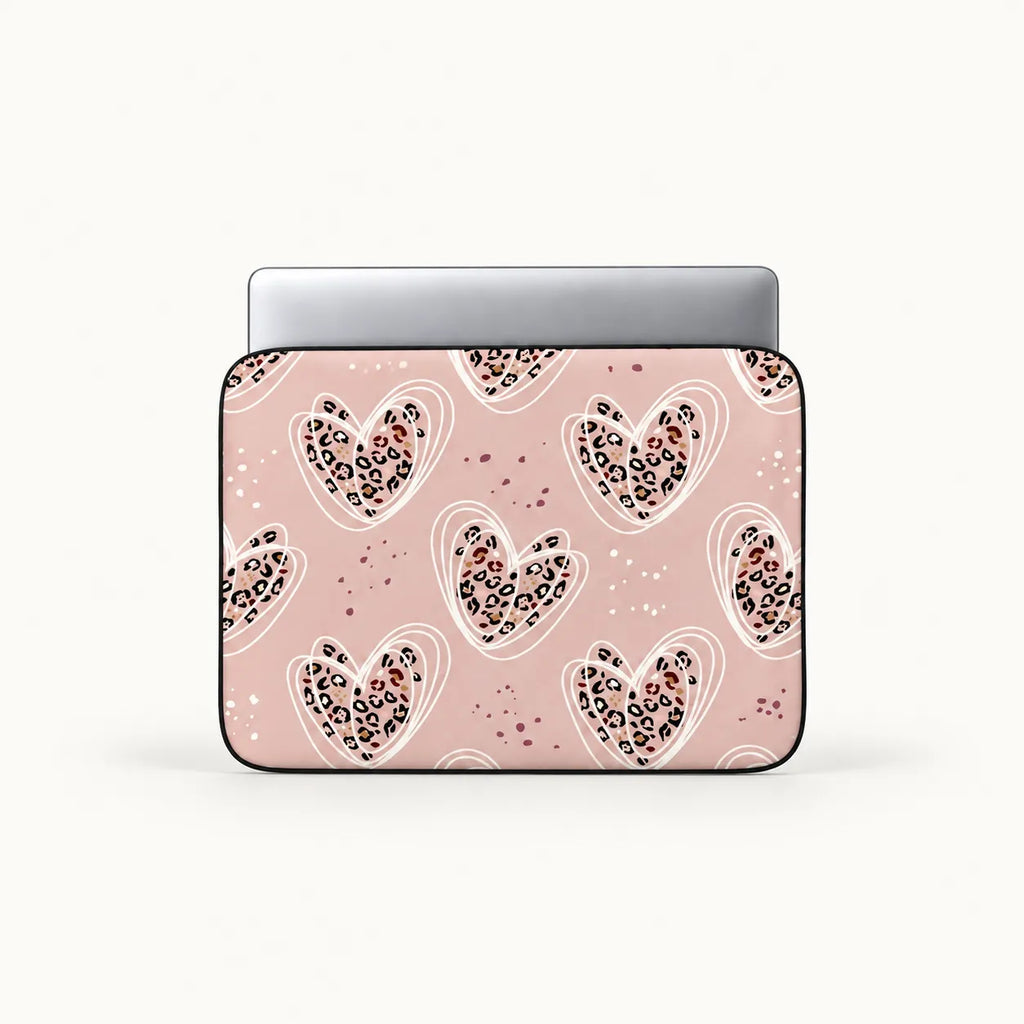Dusty pink laptop sleeve printed with leopard pattern hearts encircled by white line art by SLEEVER