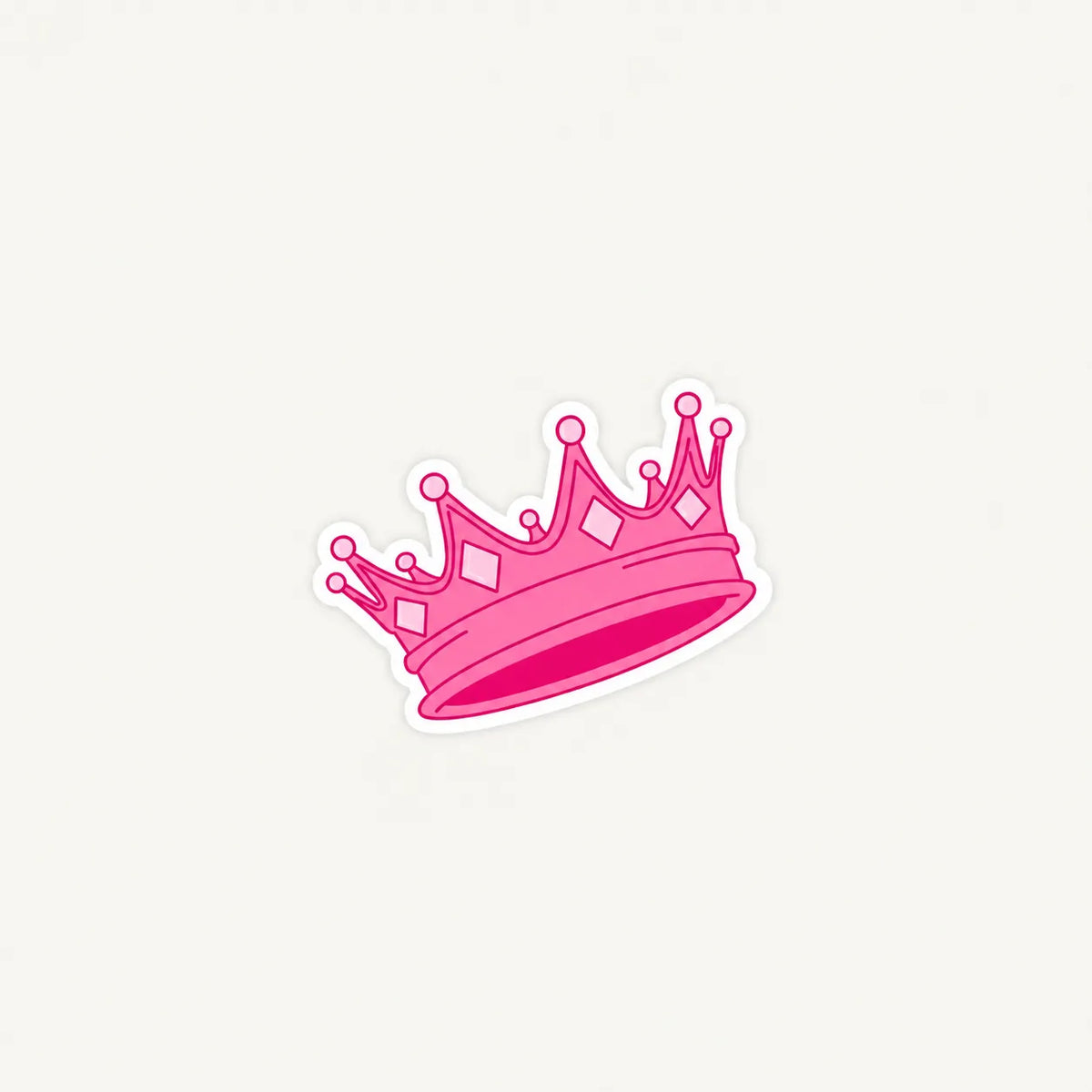 A pink cartoon-style crown sticker with a white outline, centered on a light off-white background.
