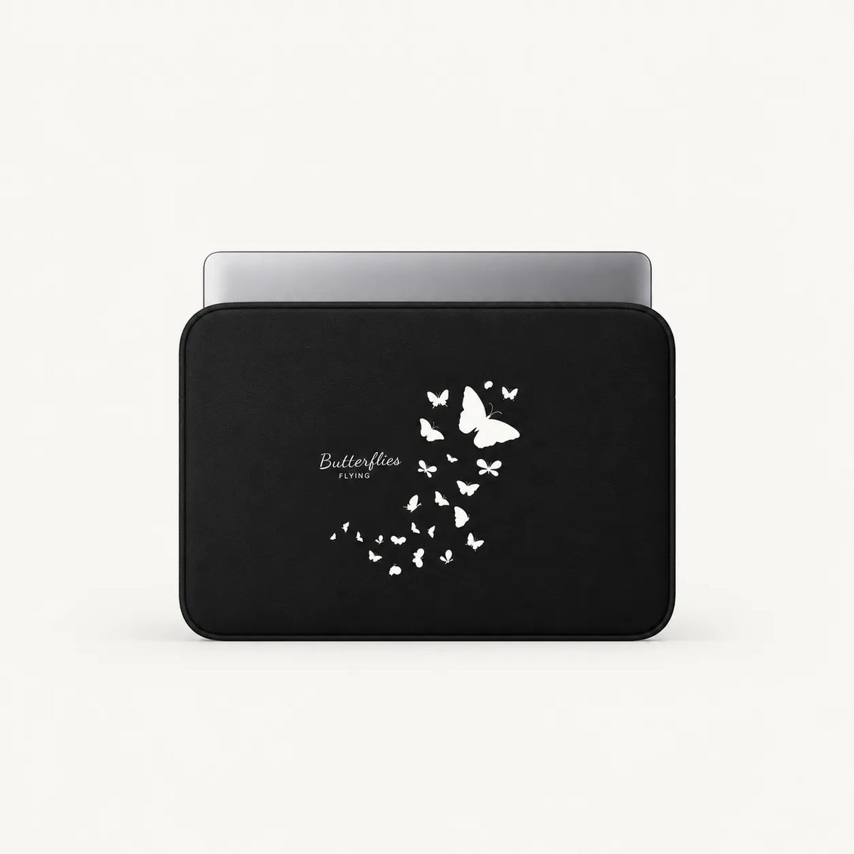 Black padded laptop sleeve featuring a white flying butterflies print with a laptop partially inserted inside.