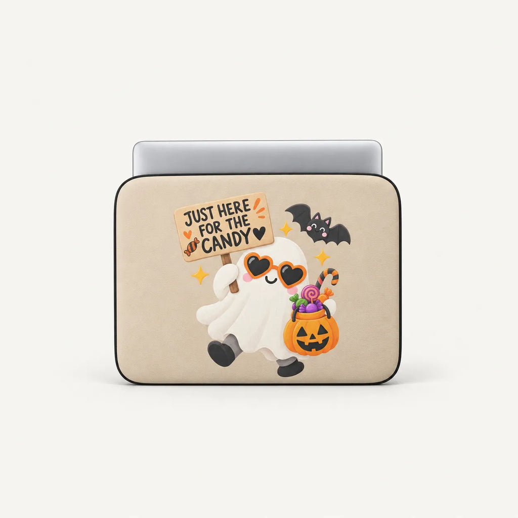 A beige laptop sleeve featuring a cute Halloween graphic of a smiling ghost holding a sign that says 'JUST HERE FOR THE CANDY' and carrying a pumpkin bucket of candy, shown on a light gray background.