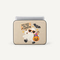 A beige laptop sleeve featuring a cute Halloween graphic of a smiling ghost holding a sign that says 'JUST HERE FOR THE CANDY' and carrying a pumpkin bucket of candy, shown on a light gray background.