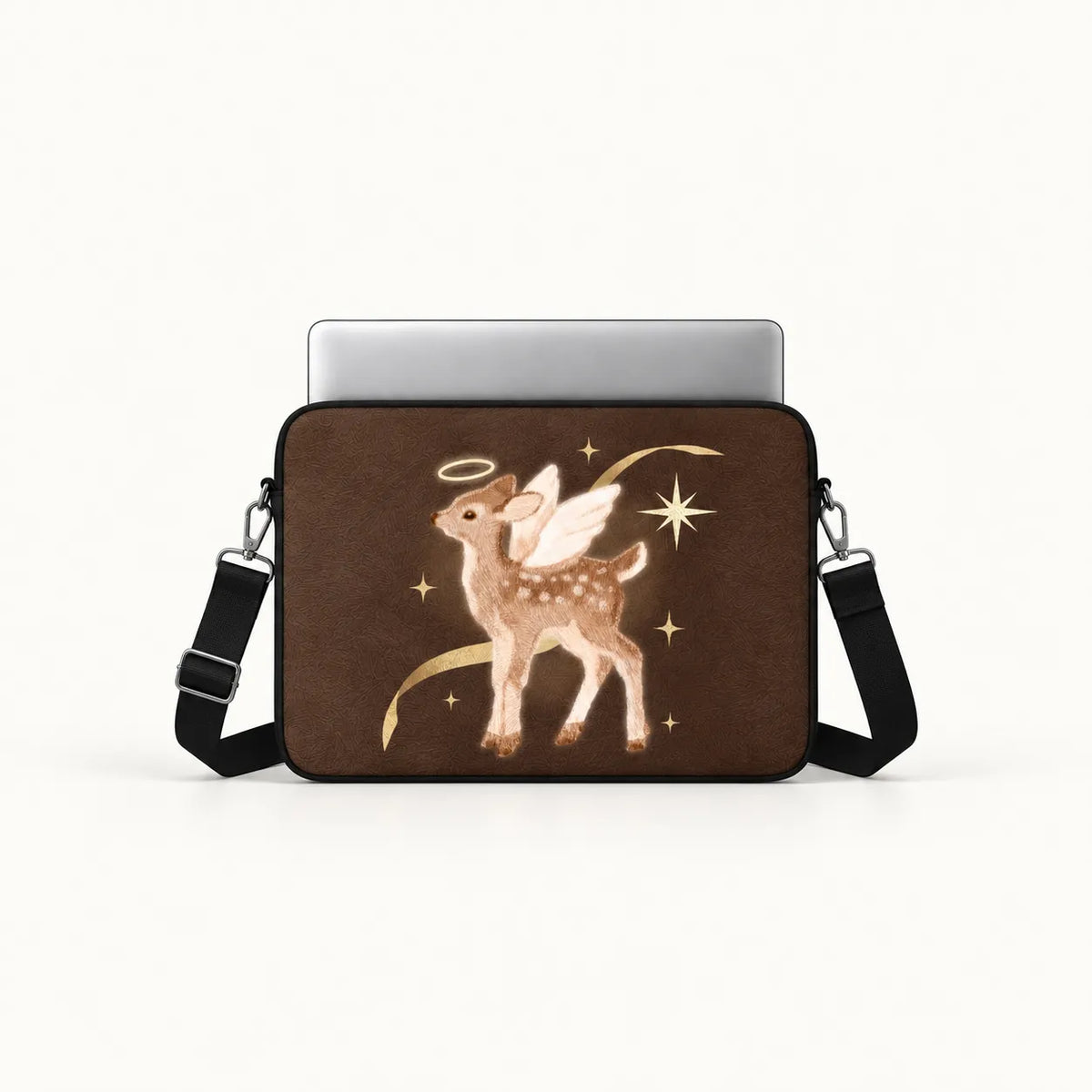 A brown laptop sleeve featuring a graphic of a winged deer with a halo and gold stars, shown with a silver laptop and black shoulder strap on a white background.