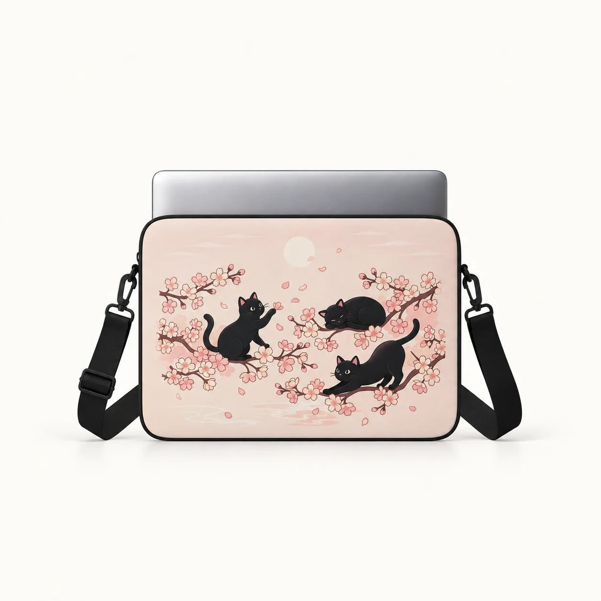 Three black cats playing among Japanese cherry blossom sakura branches on a pastel pink padded laptop sleeve by SLEEVER