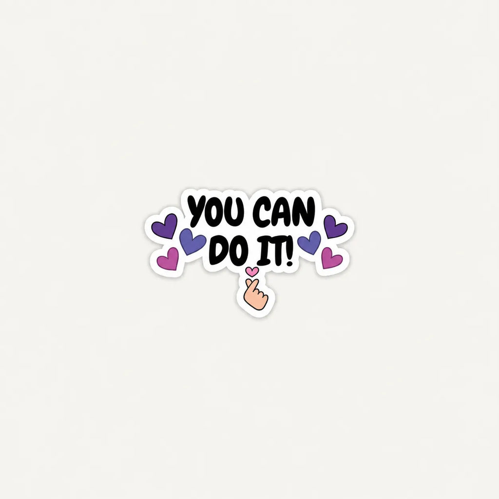 A die-cut sticker with the motivational phrase 'YOU CAN DO IT!' in black lettering, surrounded by purple and pink hearts and a small hand pointing upward, shown on a plain light background.