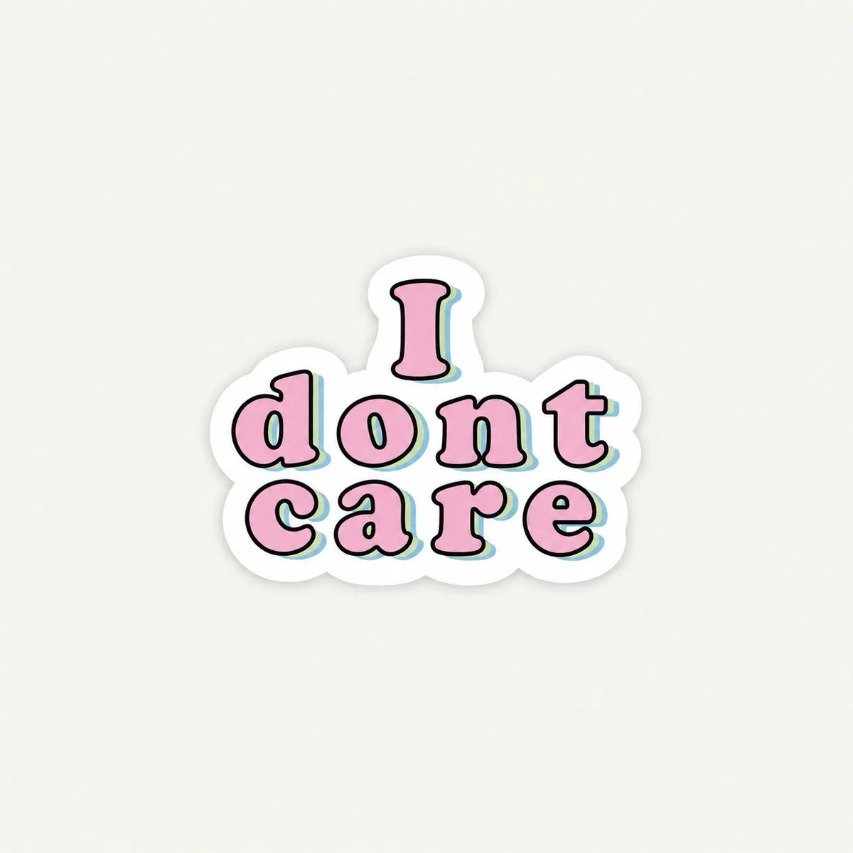 A die-cut sticker with the phrase 'I dont care' in pink bubble letters outlined in black, with a white border and a subtle light blue shadow, centered on a light gray background.