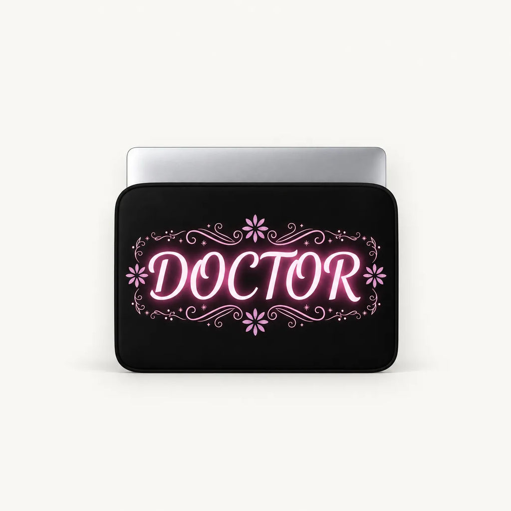 Glowing pink neon DOCTOR typography with floral flourishes on a black padded laptop sleeve by SLEEVER   