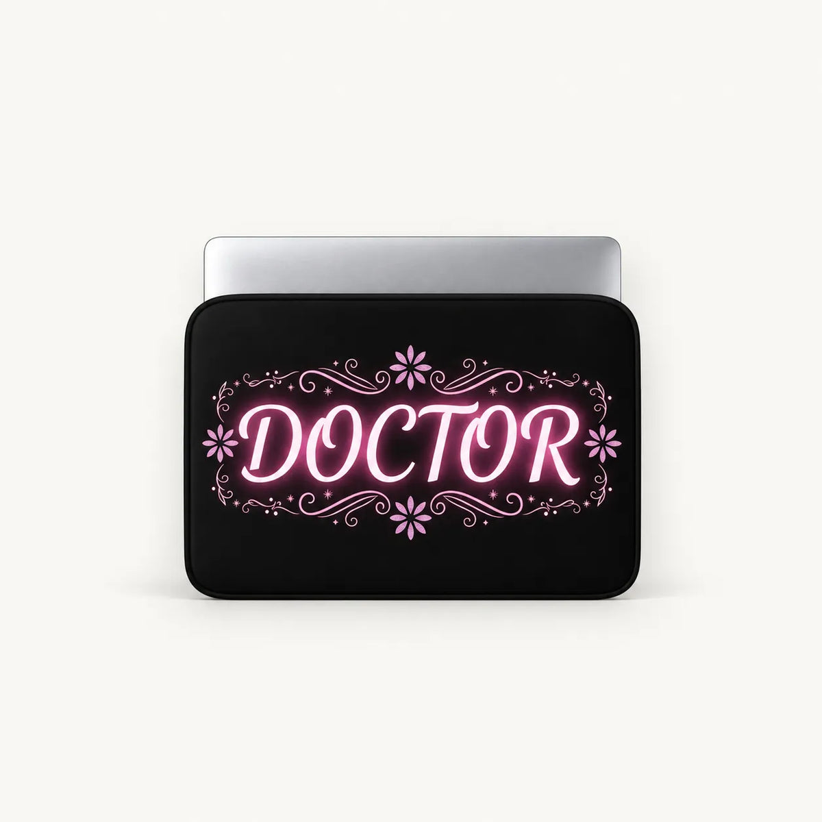 Glowing pink neon DOCTOR typography with floral flourishes on a black padded laptop sleeve by SLEEVER   