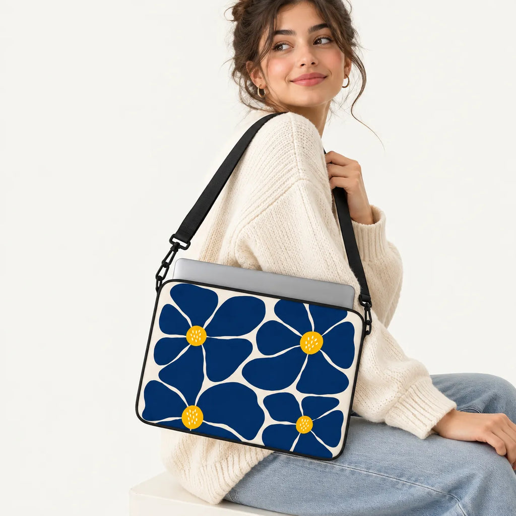 Bold dark blue retro floral print with yellow centers on a beige cream padded laptop sleeve by SLEEVER