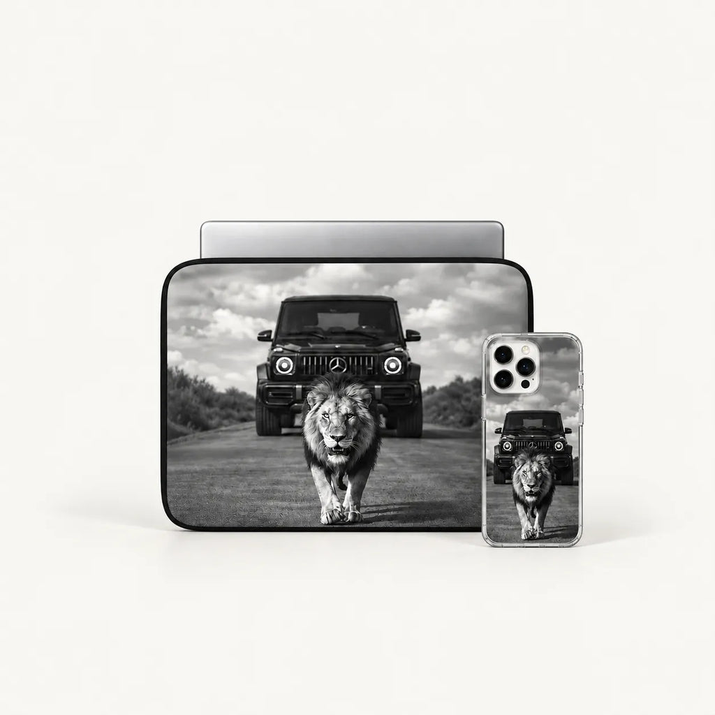 A black laptop sleeve and a clear smartphone case, both printed with a black-and-white safari scene featuring a lion walking toward the camera and a dark off-road vehicle behind it, shown on a light gray background.