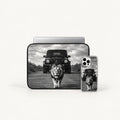 A black laptop sleeve and a clear smartphone case, both printed with a black-and-white safari scene featuring a lion walking toward the camera and a dark off-road vehicle behind it, shown on a light gray background.