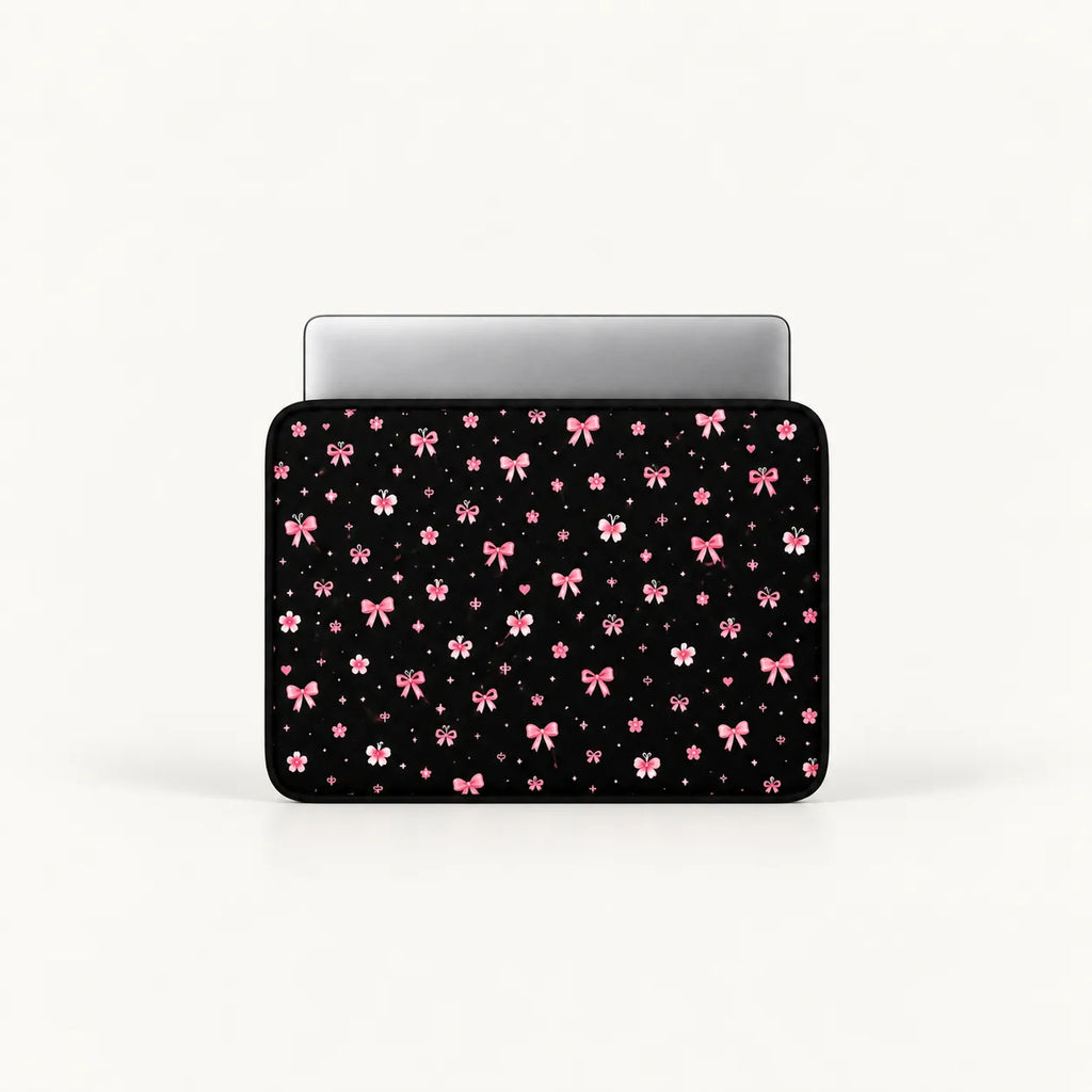 Cute pink ribbon bows, flowers, butterflies, and sparkling stars pattern on a black padded laptop sleeve by SLEEVER