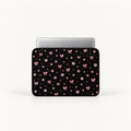 Cute pink ribbon bows, flowers, butterflies, and sparkling stars pattern on a black padded laptop sleeve by SLEEVER