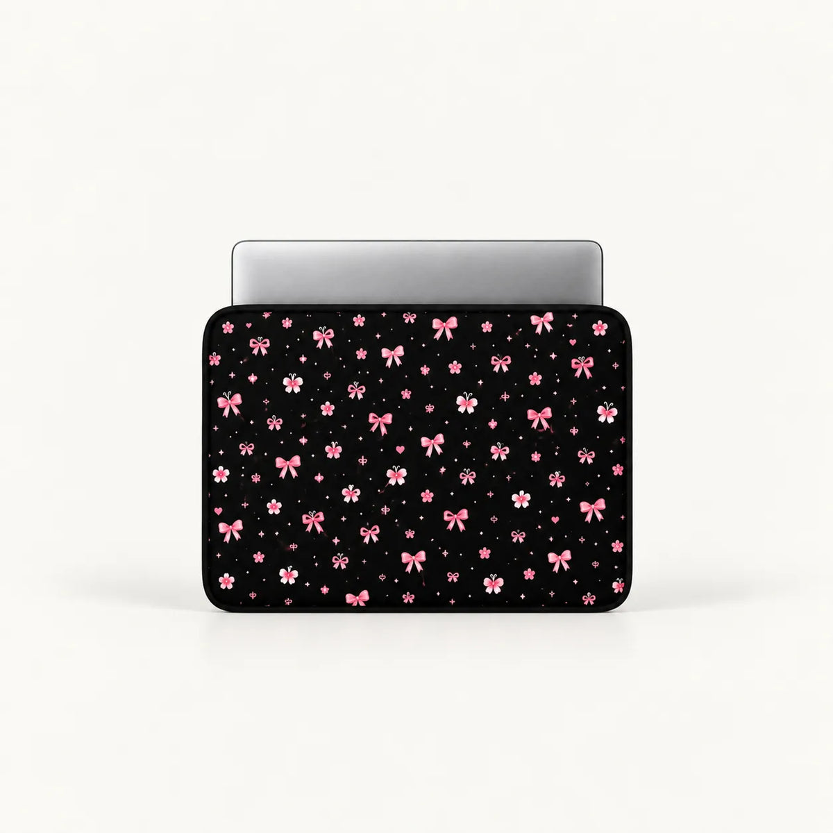 Cute pink ribbon bows, flowers, butterflies, and sparkling stars pattern on a black padded laptop sleeve by SLEEVER
