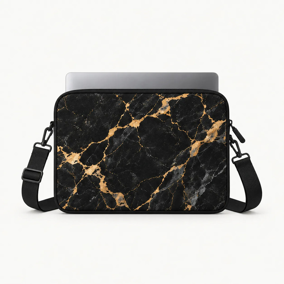 Front-view mock-up of SLEEVER padded laptop sleeve in black and gold marble pattern with silver laptop inside