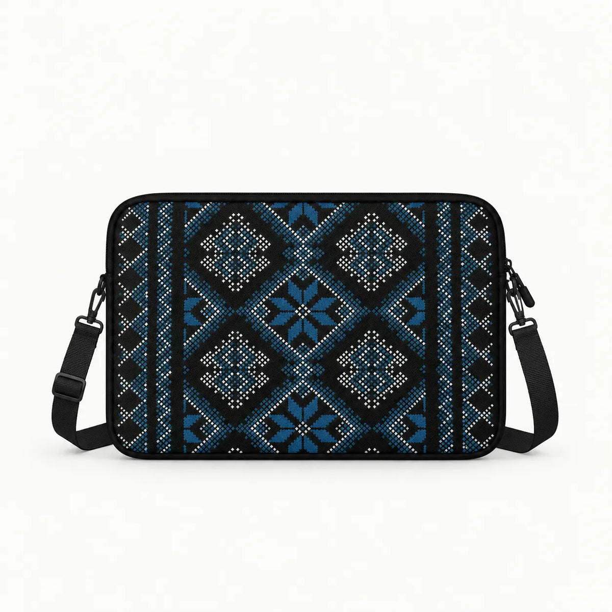 A rectangular crossbody laptop bag with a black base and a detailed blue, white, and black geometric pattern, shown against a plain white background.