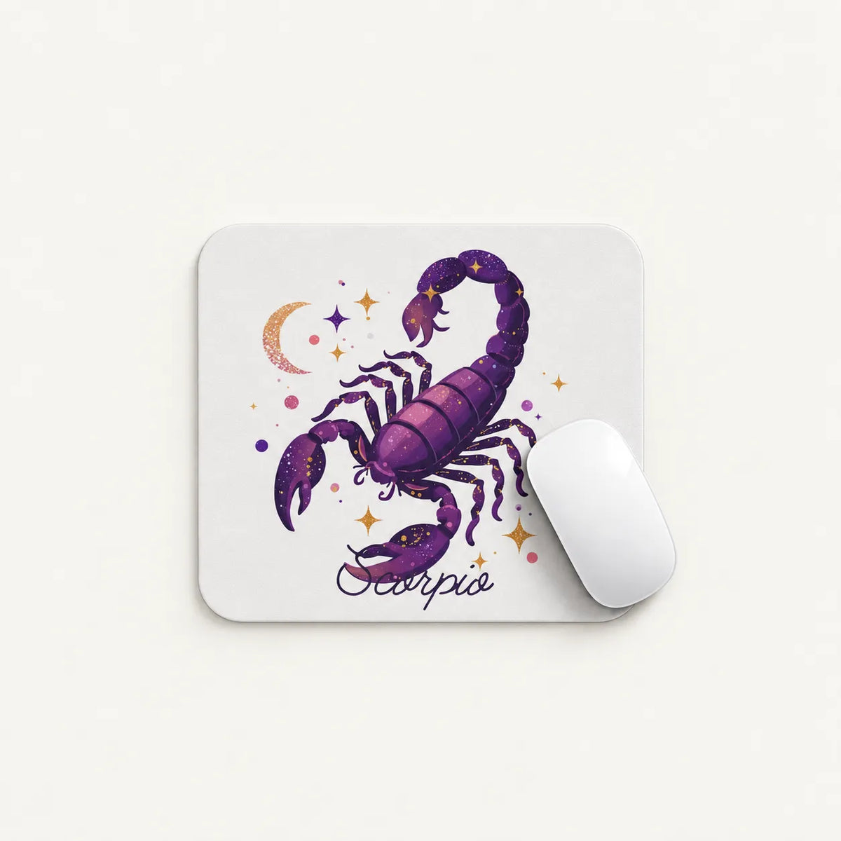 A white rectangular mouse pad with rounded corners featuring a purple scorpion illustration and the word 'Scorpio' beneath it, shown on a light neutral background with a white computer mouse resting on it.