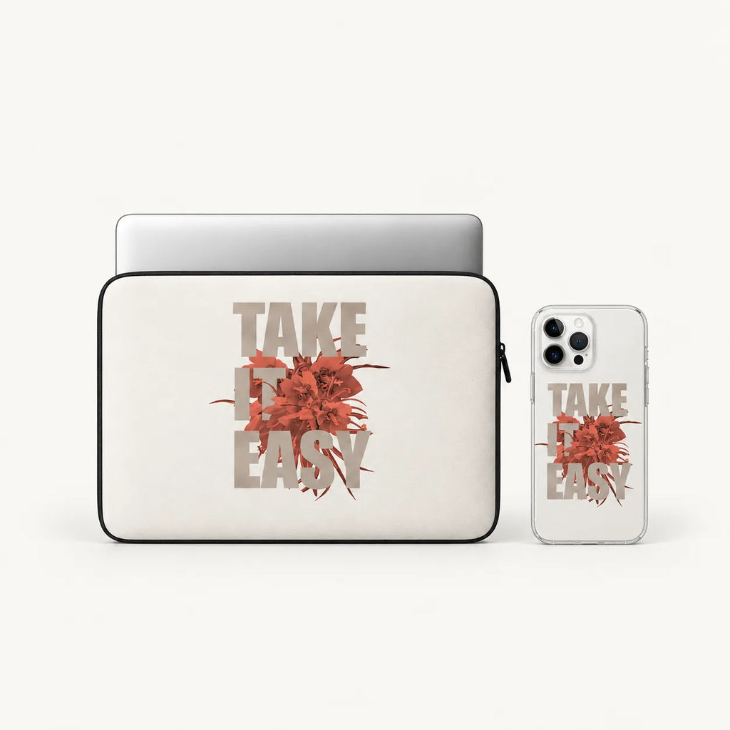 A laptop sleeve and a clear phone case, both printed with the phrase 'TAKE IT EASY' in beige letters over a red floral burst, shown on a light gray background.