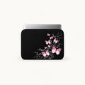 Elegantly glowing pink butterflies floating over silvery swirl vines on a black padded laptop sleeve by SLEEVER