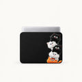 Stacked cute cartoon black, white, and orange kittens on a black padded laptop sleeve by SLEEVER