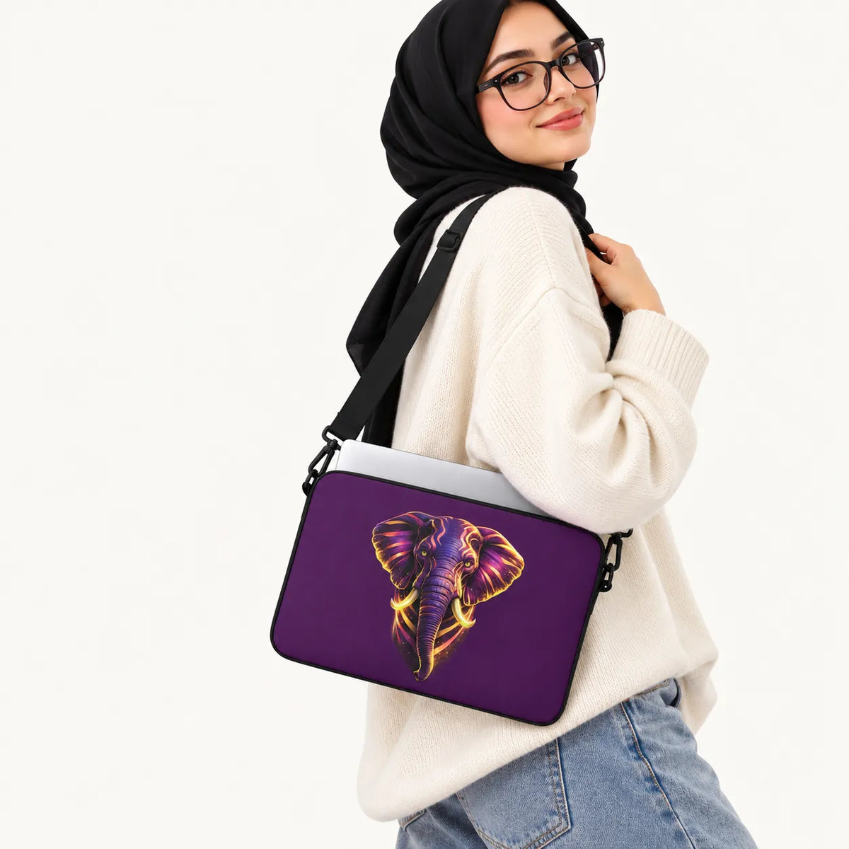 Majestic elephant head artwork with glowing purple and gold neon accents on a dark purple padded laptop sleeve by SLEEVER