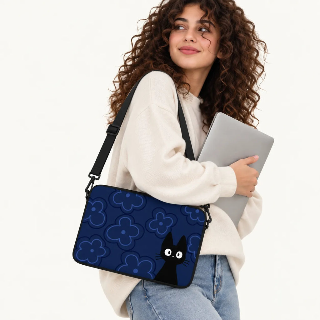 Cute black cat with big white eyes on a dark navy floral background on a padded laptop sleeve by SLEEVER
