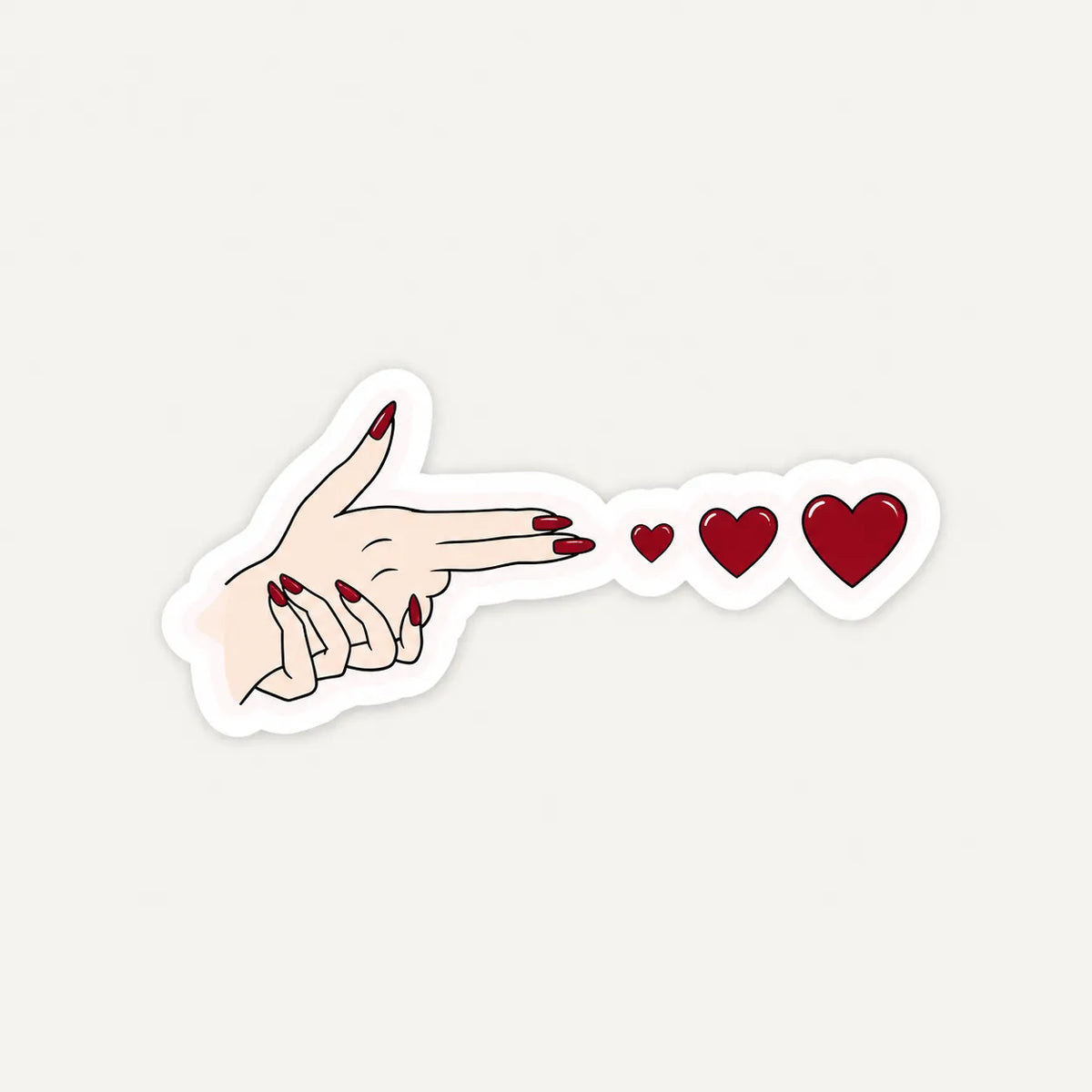 Female hand in a finger gun gesture shooting red hearts sticker with red nails by SLEEVER   