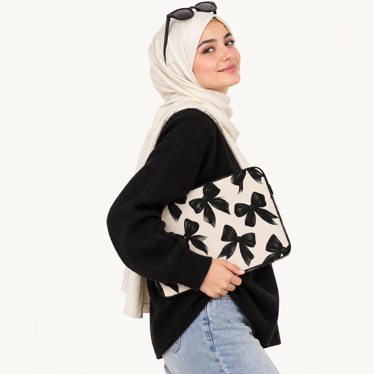 Elegantly painted black satin ribbon bows seamless pattern on beige padded laptop sleeve by SLEEVER