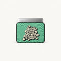 A laptop sleeve featuring a retro wavy green and teal pattern with the phrase 'Enjoy Every Moment' in stylized cream lettering, shown on a light gray background.